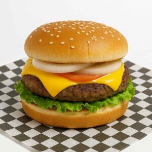 Hyper-realistic 1/2 lb Cheeseburger on check deli paper with a juicy half-pound beef patty topped with melted American cheese, crisp lettuce, tomato slices, and onion rings, served on a sesame seed bun. Perfect cheeseburger or lunch near me in Newport News.