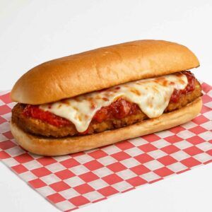 Hyper-realistic Chicken Parmesan Hero on check deli paper with a crispy breaded chicken cutlet topped with marinara sauce and melted mozzarella cheese, served on a toasted hero roll. Perfect chicken parmesan sandwich or lunch near me in Newport News.