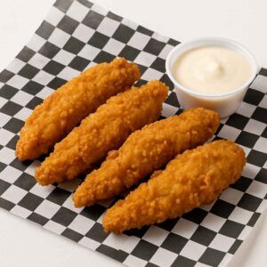 Four crispy golden-brown chicken tenders served on black-and-white check deli paper with dipping sauce, styled for NYC Kings Deli in Newport News, VA.