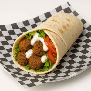 Hyper-realistic Falafel Wrap on check deli paper with crispy seasoned falafel balls, fresh lettuce, tomato slices, onions, and creamy white sauce wrapped in soft pita bread. Perfect vegetarian Halal food or lunch near me in Newport News.