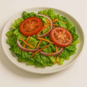 Hyper-realistic Hot Honey House Salad served on a white plate with fresh romaine lettuce, tomato slices, red onion, and shredded carrots, lightly dressed in hot honey vinaigrette. Perfect healthy lunch near me in Newport News.
